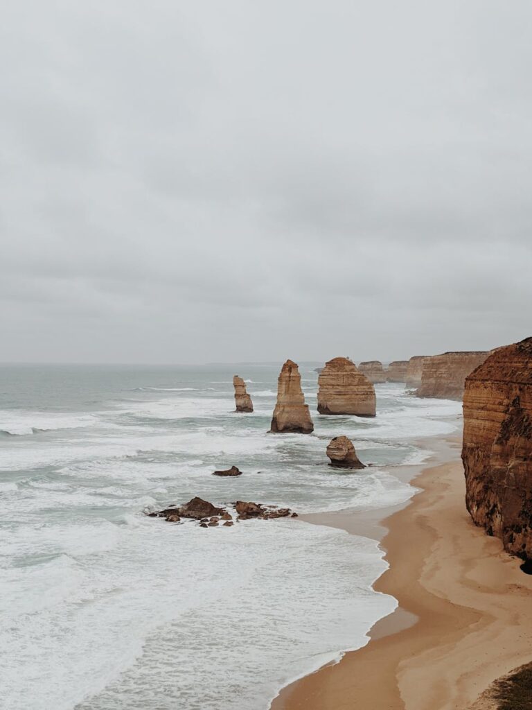 brown rock formation on sea shore